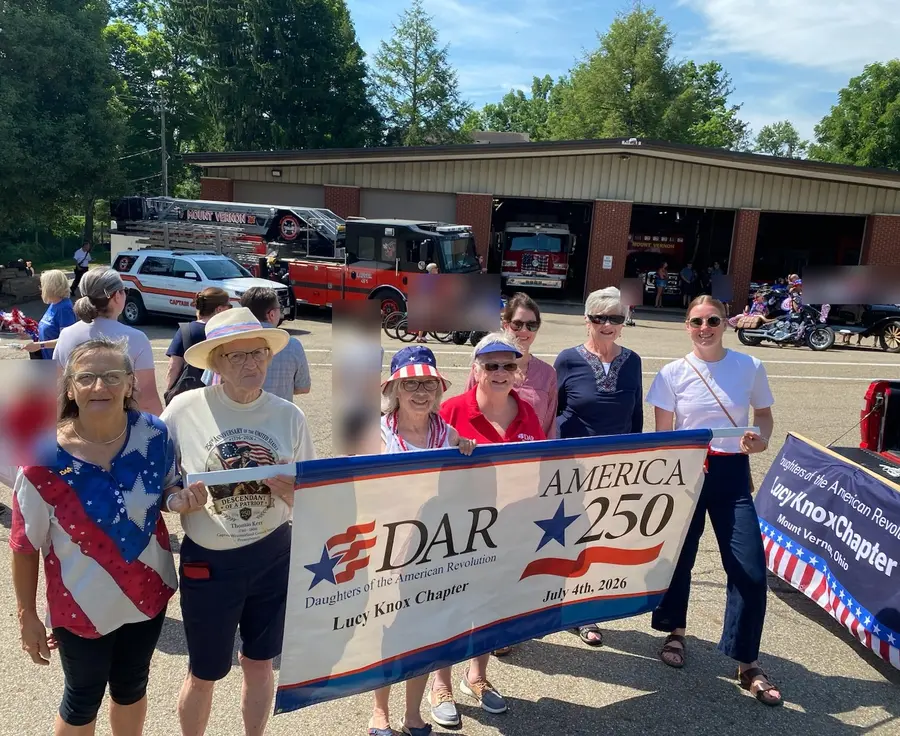 Chapter members marching with the DAR America 250 banner in the July 4th parade